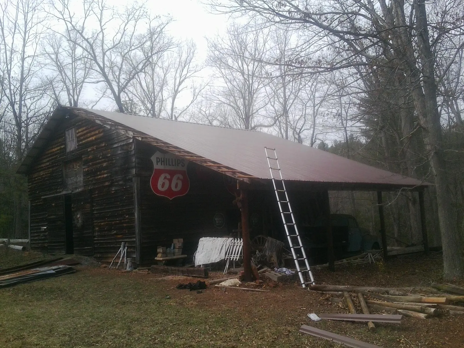 New metal roof on an open sided timber barn with a vintage sign in Woodleaf