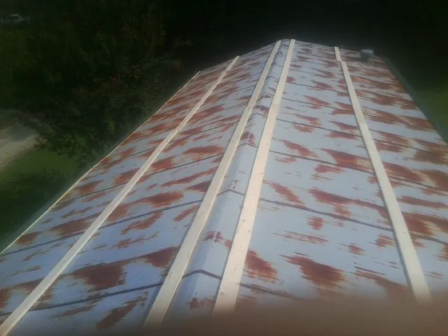Rusted metal roof panels with new wood purlins before replacement — Storm Damage Roof Repair in Woodleaf by Roofing Brothers